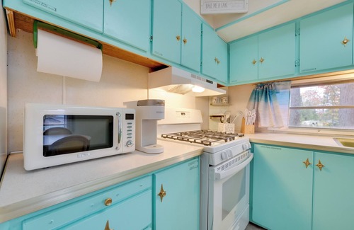 Kalkaska Casa | Walk to Manistee Lake: Retro Cottage w/ Fire Pit!