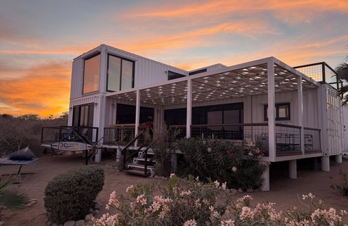 El Sargento Casa | 3 bedroom, 3 bath premium stylish shipping container home. Game room w/ darts, shuffleboard, video game cabinet, Infinity game table, new 8 person hot tub, multiple decks w/ firepits, fast Wifi ( 250 mb+)w/ Starlink backup. Free use of two SUPs.