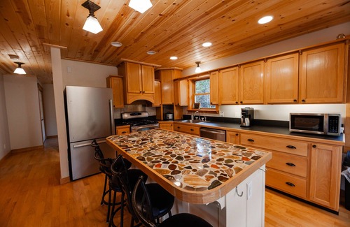 Champion Casa | ATV-Snowmobile Trail, Large home, sits on the peshekee river. sleeps 18 people.