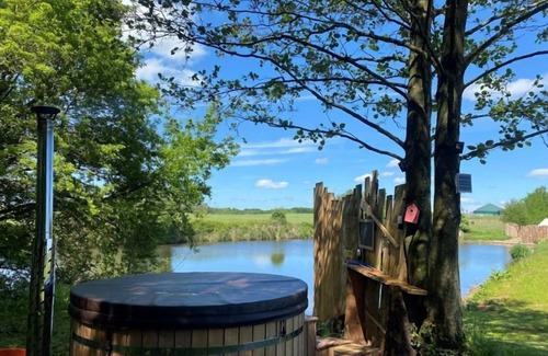 Washford Cabina | Bell tent in ultimate luxury with a wood fired hot tub, super king size bed