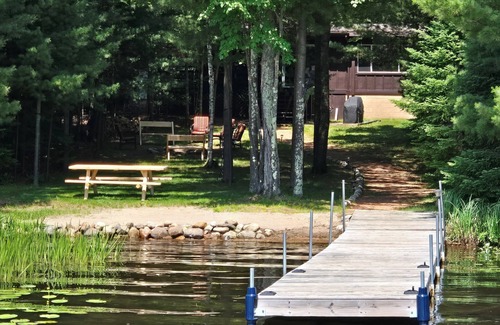 Eagle River Casa | Cabin on Voyageur Lake–2BR Retreat on ER Chain w/ Deck, Firepit & Sandy Beach!