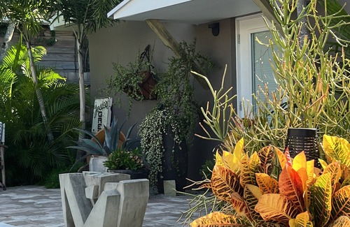 Parrot Cove Cabaña | Chill on the patio overlooking the pool & lush gardens with privacy!