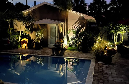 Parrot Cove Cabaña | Chill on the patio overlooking the pool & lush gardens with privacy!