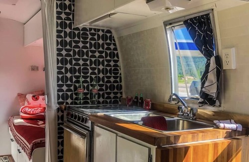 Irwin Casa | Coca-Cola themed 1968 Airstream. Walk to the Snake River.