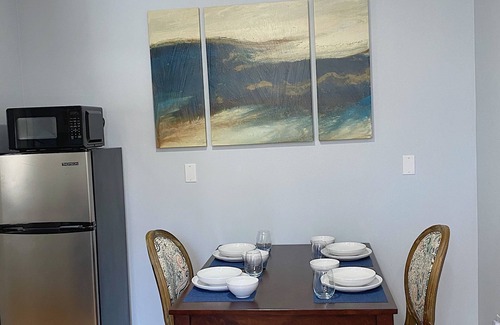 Coram Apartamento | Cozy king suite with kitchen and dining area.