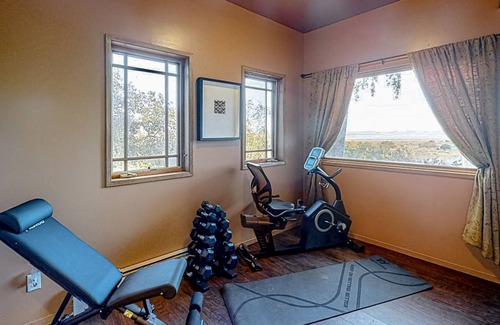 Black Point-Green Point Casa | Gorgeous river view home with wood stove, sauna, patio, fitness room, & kitchen