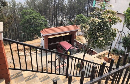 Kirtipur Casa | Home is located on the side of a mountain near a famous Buddhist monastery.