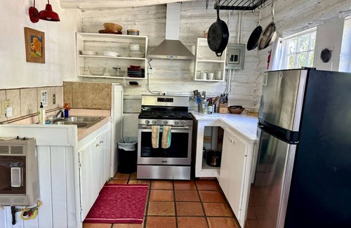 San Cristobal Cabina | Log Casita Overlooking Pond and Waterfall near Taos, New Mexico