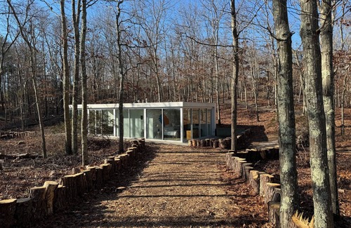 Water Mill Casa | Modernist Glass House nestled in tall pines and nature offering total privacy