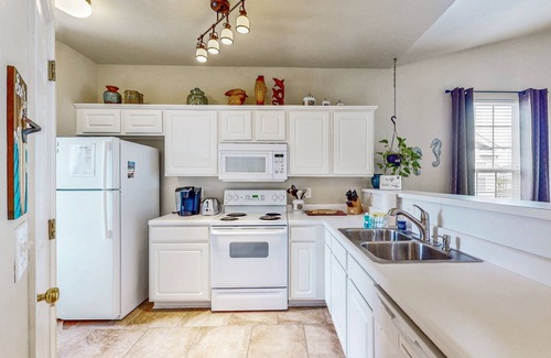 Sunset Beach Condominio | Pond-front condo near beach with balcony, pool, & hot tub - snowbird-friendly