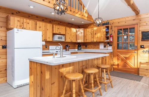 Eagle River Casa | Porch in the Pines | Lakefront home w/ AC! Sandy Beach, Dock, Dogs OK