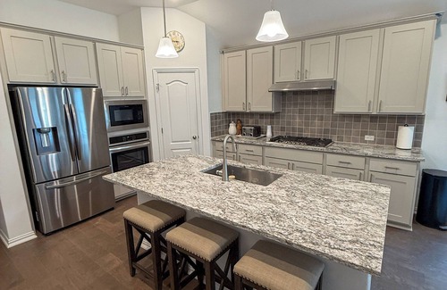 Buda Casa | Spacious 4BR Escape with Hot Tub, Laundry, and Pools in Buda.
