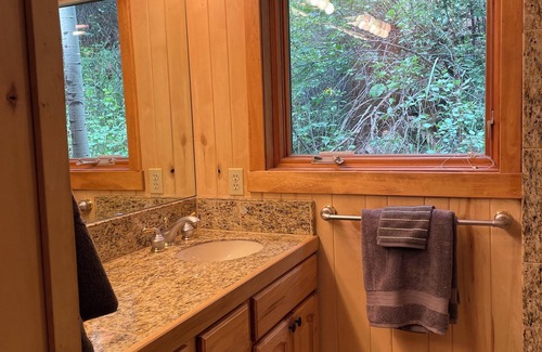 Lyons Cabina | Streamside Cabin nestled in Rock Canyon Walls with Creek flowing through it