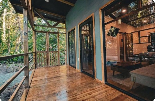 Bocas del Toro Cabina | Surfside tiny home with modern amenities like AC, modern design, bathtub,and TV.