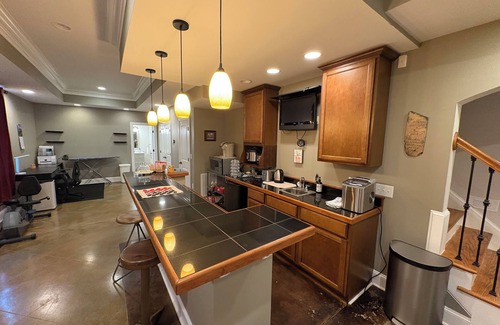 Raleigh Apartamento | Walkout Basement apartment with a private entrance facing a wooded backyard.