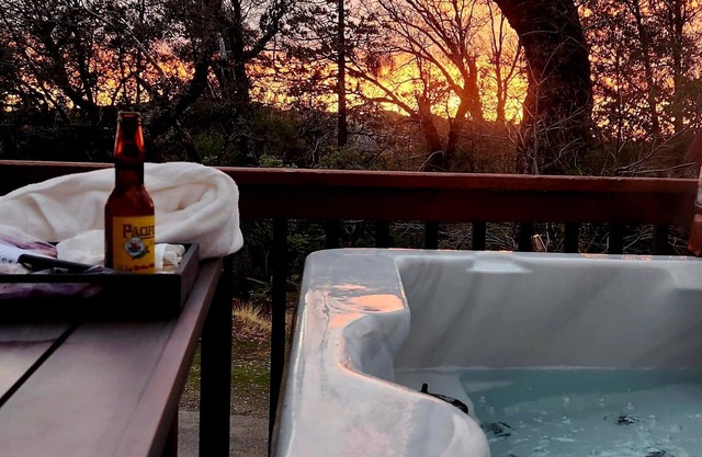 2 Br 2 Ba upstairs in cabin w/hot tub on 5.6 acre. Next to a Creek /near a lake