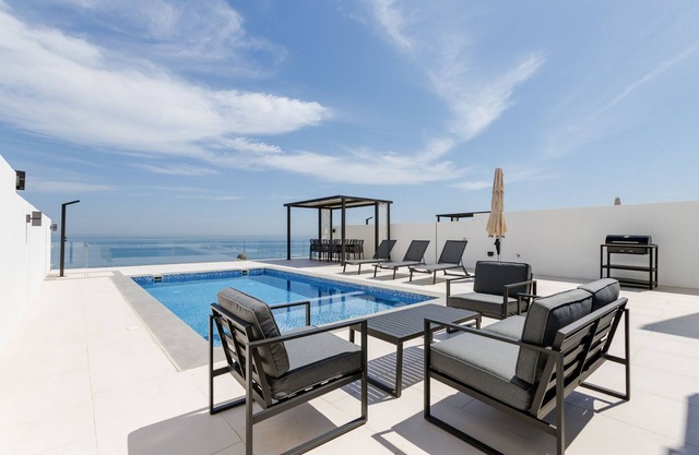 4BR Villa with Arabian Gulf, Mountain, Community Views and Heated Pool