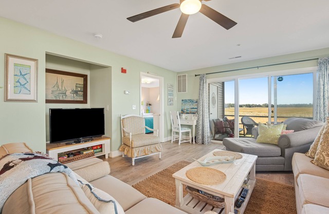 Bethany Bay condo with pool, fireplace, screened porch & AC