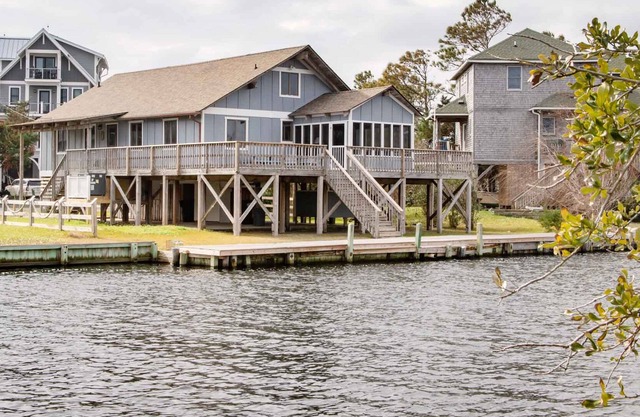 Cute, canal-front home in quiet area with great deck space, screened porch & AC