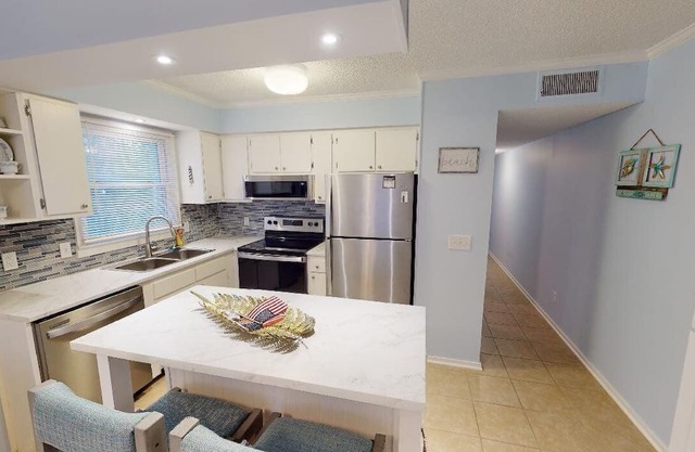 Discover enchanting courtyard living in this stunningly updated Ocean Winds.