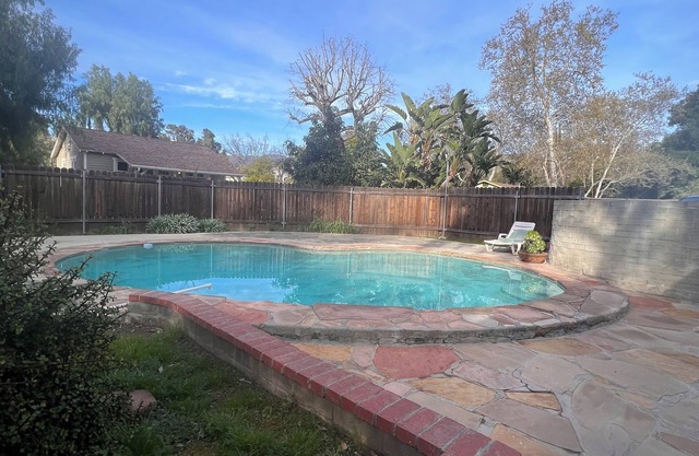 Dog friendly cottage with porch, pool, massive yard, and plenty of parking.