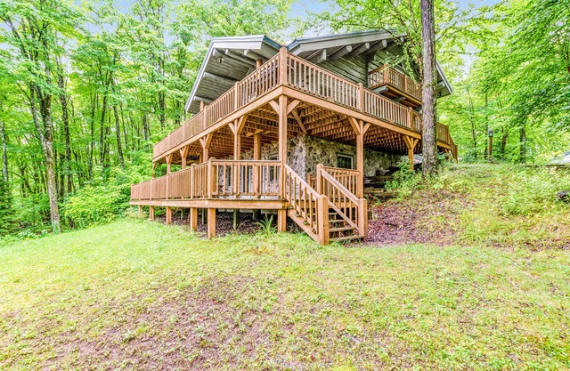 Dog-friendly, lakefront home with a wood fireplace, decks, dock, & AC
