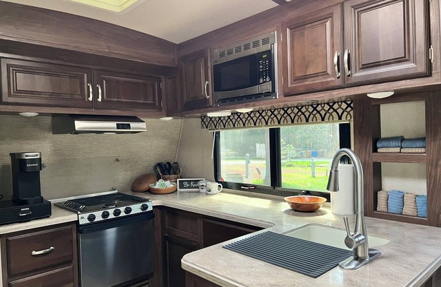 Fully Equipped Travel Trailer in beautiful campground setting.