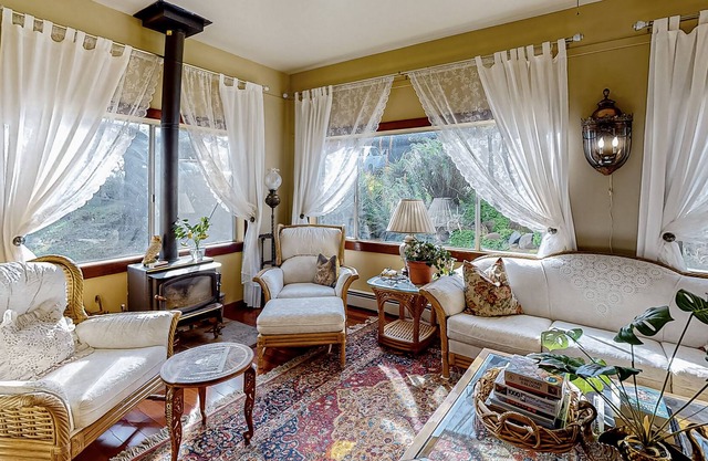 Gorgeous river view home with wood stove, sauna, patio, fitness room, & kitchen