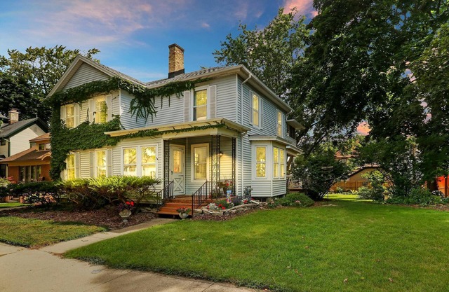 Historic house on tree lined red brick street of historic homes.