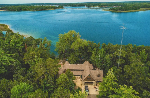 Luxury Lake Belle Taine retreat with private beach, sauna & four-season fun.