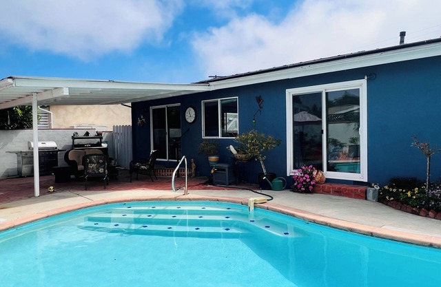 Relax at this Family Home w/ Solar heated Pool & Game Room. Close to everything!
