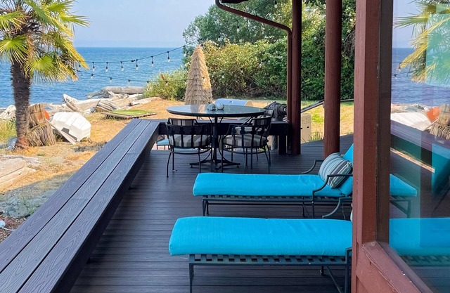 Spacious waterfront retreat with inviting deck, fireplace & games