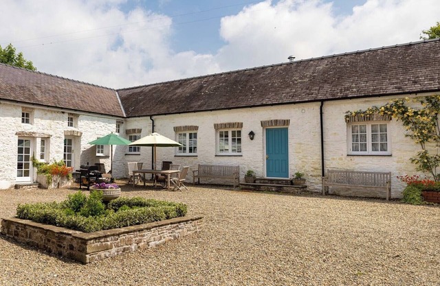 THE OLD CARRIAGE COURT, pet friendly, with open fire in Kidwelly