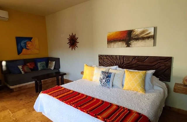 The Sol Studio Suite with balcony overlooking the pool and garden area