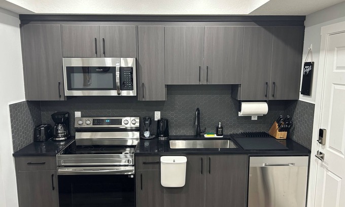 Calgary Casa | Charming 1-Bedroom Basement Walkout Suite with a Gym and Office.