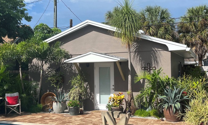 Parrot Cove Cabaña | Chill on the patio overlooking the pool & lush gardens with privacy!