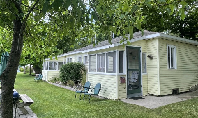 Ludington Cabaña | Cottage 2 is a 2 bedroom 25’ from its boat dock & Hamlin Lake