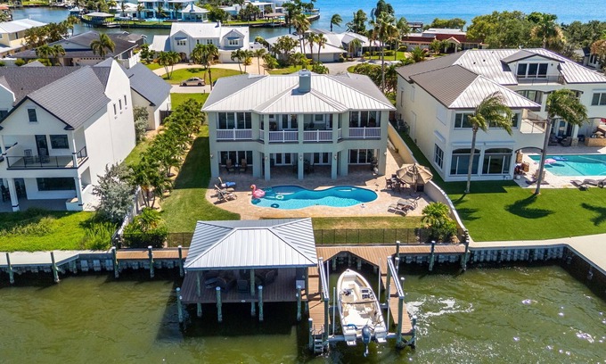 Cocoa Isles Country Club Casa | Gorgeous Direct Riverfront Pool Home W/ Private Balcony, Movie Room, & Fire Pit!