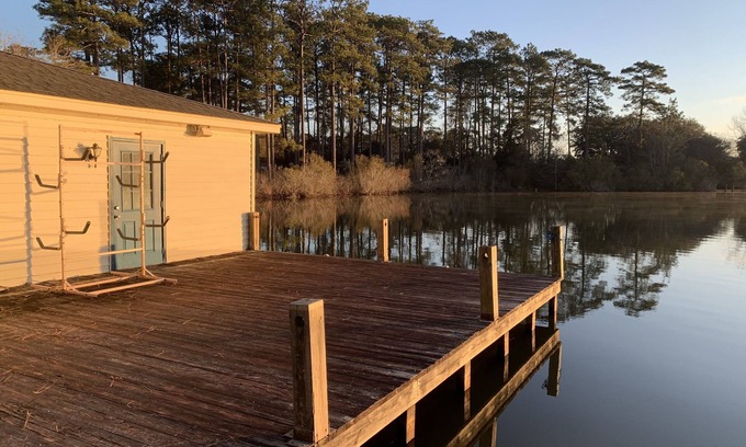 Hattiesburg Casa | Lakeside pavilion on private lake with a boathouse, outdoor fireplace, kayaks.