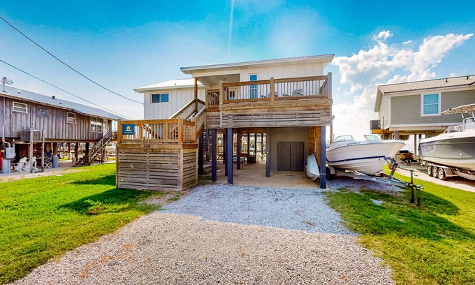 Royal Lagoons Casa | Serene sound-front home with a covered patio, dock, and swing bed