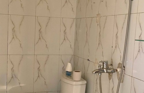 Limete Casa | Cozy Guest Room in Kinshasa with Balcony and Partial Air-Conditioning