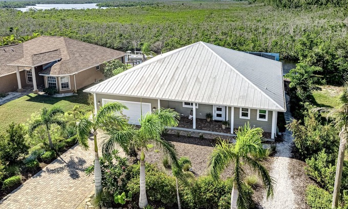 Pine Island Center Casa | Canal-side charmer with enclosed pool, waterside deck, open layout, & W/D