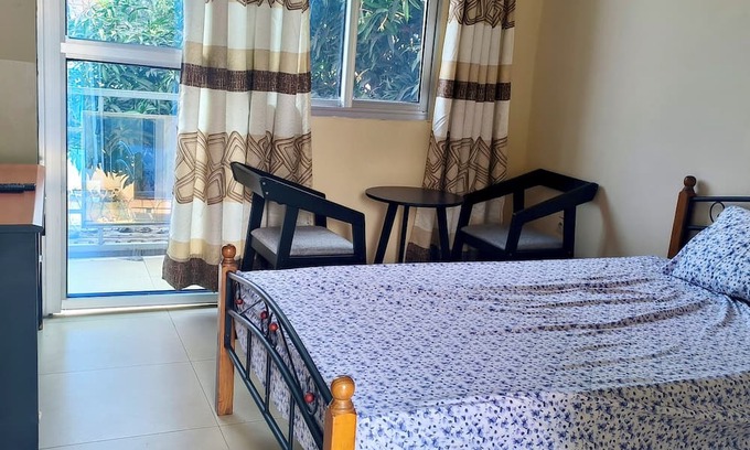 Limete Casa | Cozy Guest Room in Kinshasa with Balcony and Partial Air-Conditioning